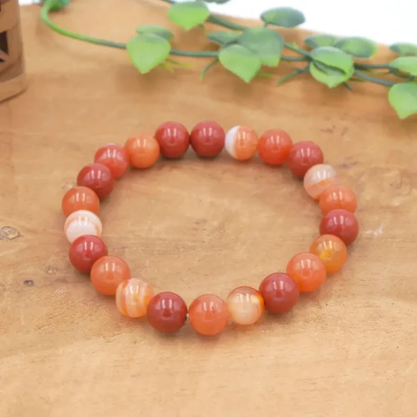 Bracelet en pierres naturelles de qualité d'aventurine orange, de cornaline et jaspe rouge, montées sur fil élastique multibrin résistant.